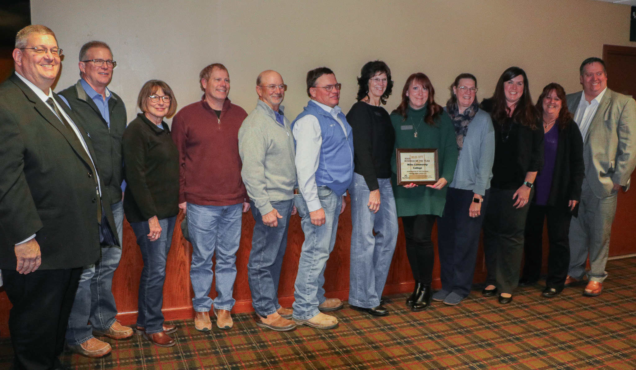 Group of adults holding award